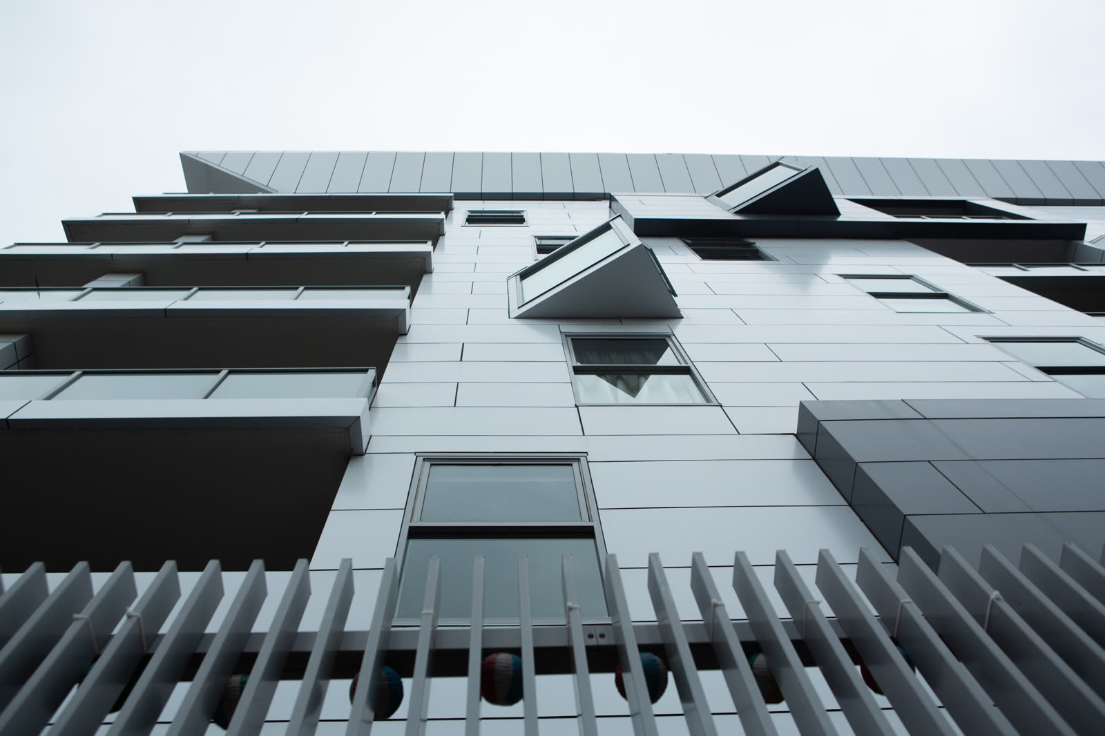 White vertical fins and angled balconies on a Sydney apartment building, detail