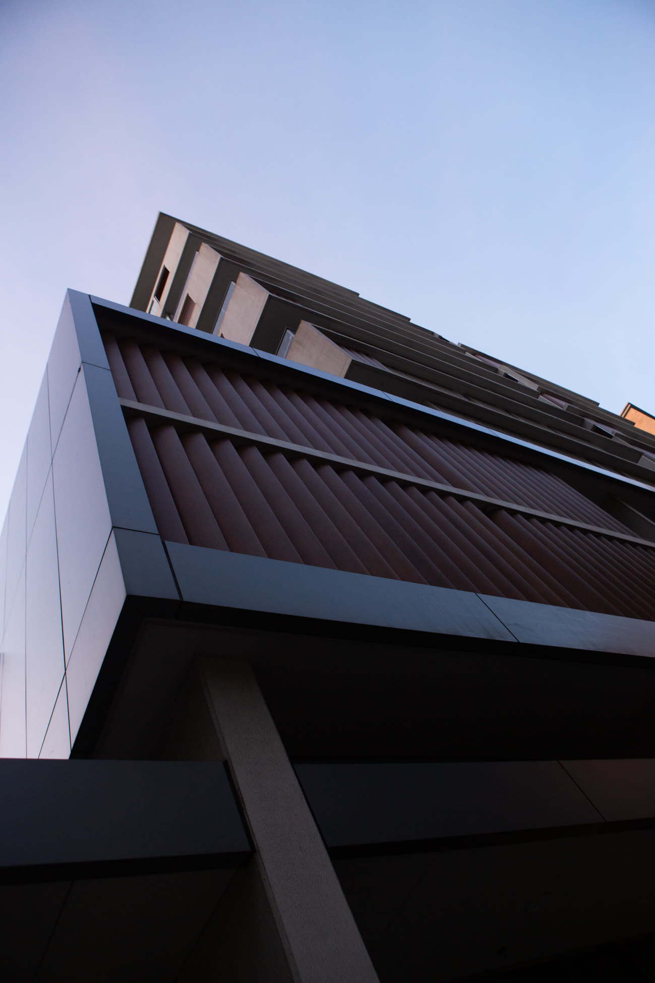 Dark angular soffit and supporting column photographed from beneath